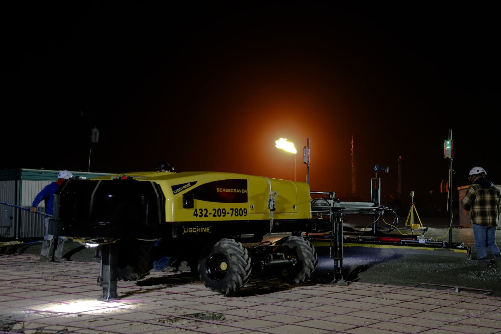 Precision Screeding equipment at a nighttime job site ready for slab work