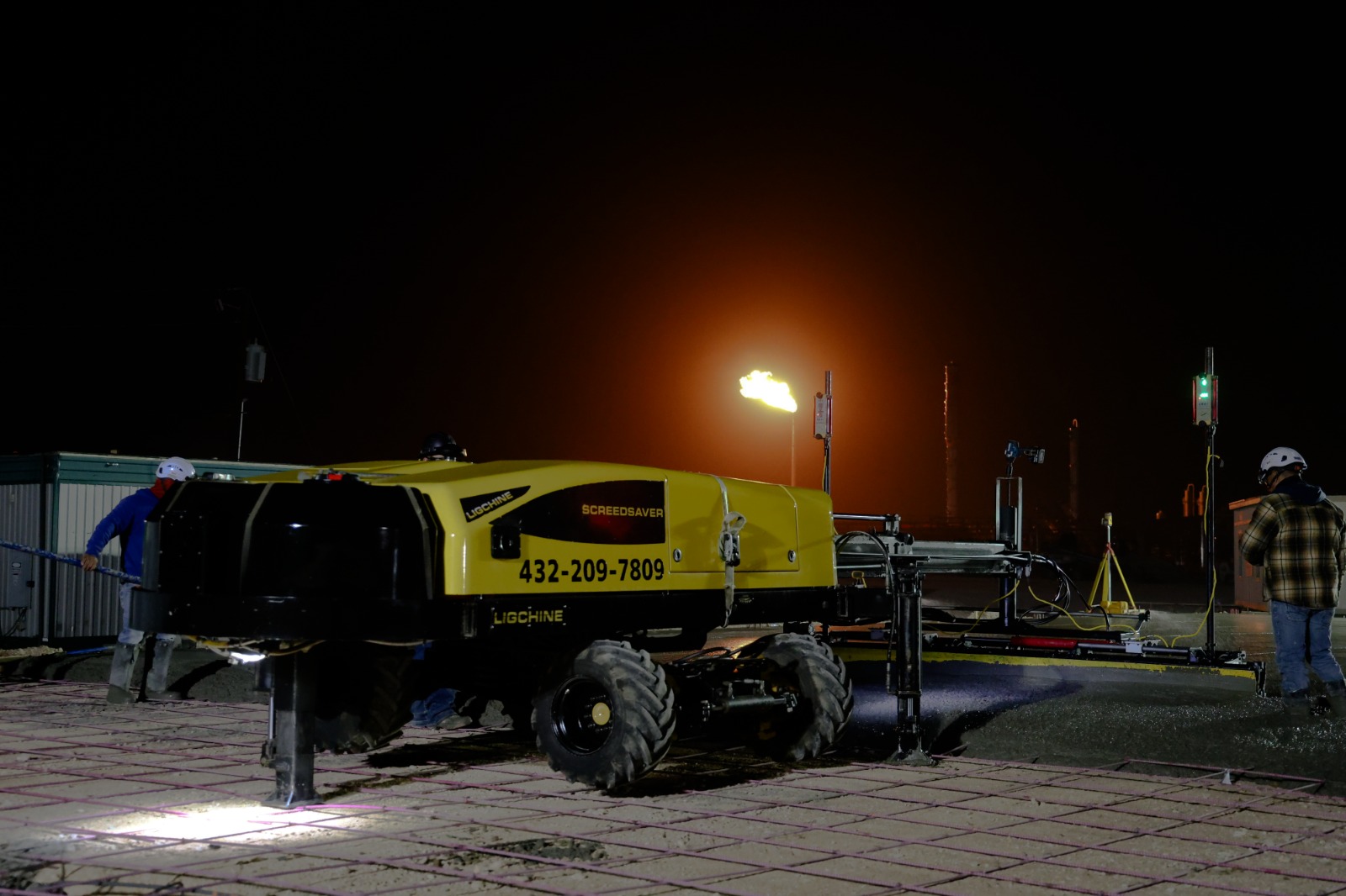 Precision Screeding equipment at a nighttime job site ready for slab work